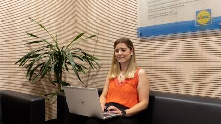 HR employee sitting by plant